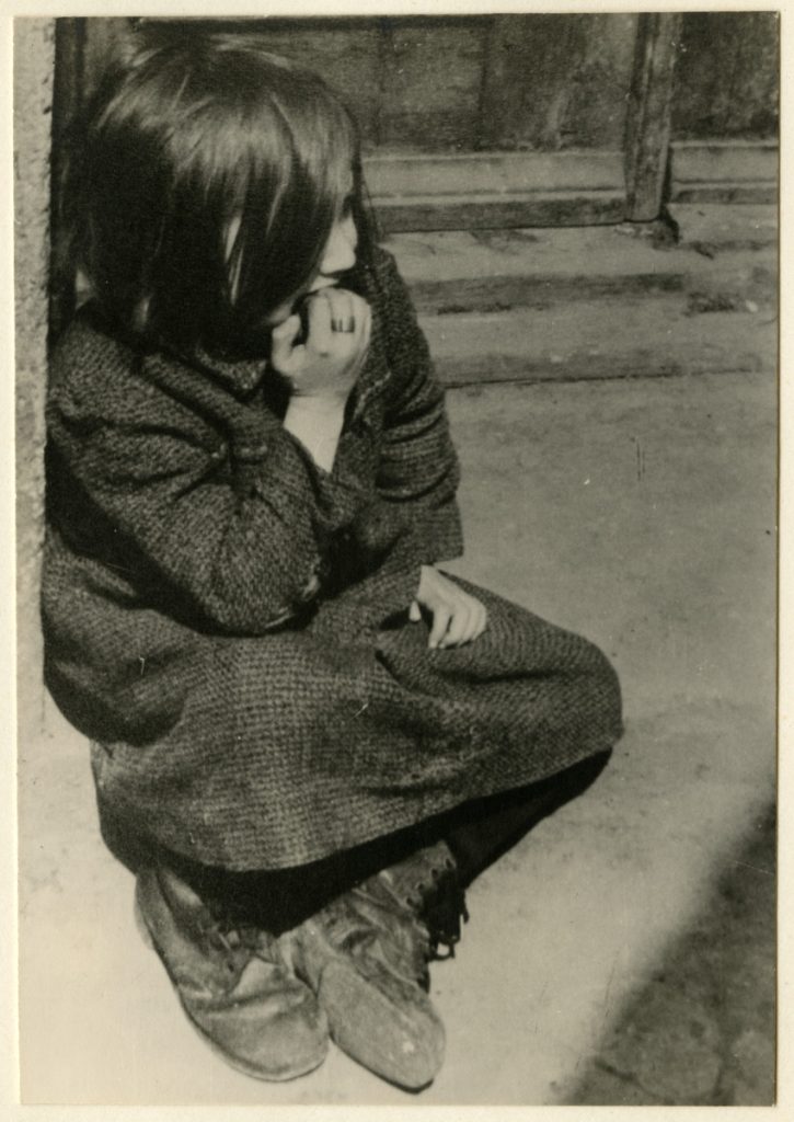 Story of Ruth - A-destitute-girl-sits-on-the-curb-of-a-street-of-the-Lodz-ghetto